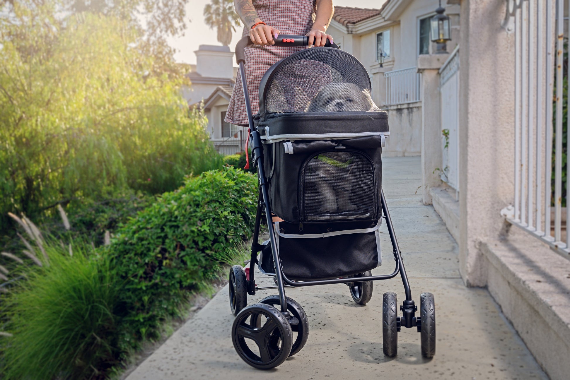 casual black pet stroller with dog